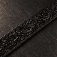 Close-up of the hand-tooled floral engraving on the Midnight Black leather strap.