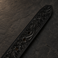 Detail of the belt tip on the DIRATH Tooled Belt in Midnight Black.