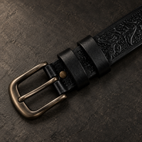 The Midnight Black Tooled Belt fastened, showing the antique-brass buckle in use.