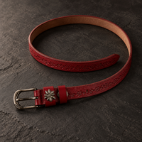 The Bordeaux Tooled Belt laid open, showing the full strap and keeper loop.