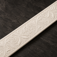 Close-up of the hand-tooled floral engraving on the Ivory leather strap.