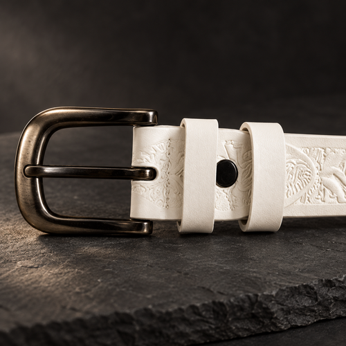Detail of the antique-brass buckle and round rivet stud on the Ivory Tooled Belt.