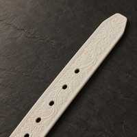 Detail of the belt tip on the DIRATH Tooled Belt in Ivory.