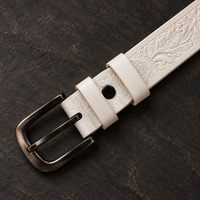 The Ivory Tooled Belt fastened, showing the antique-brass buckle in use.